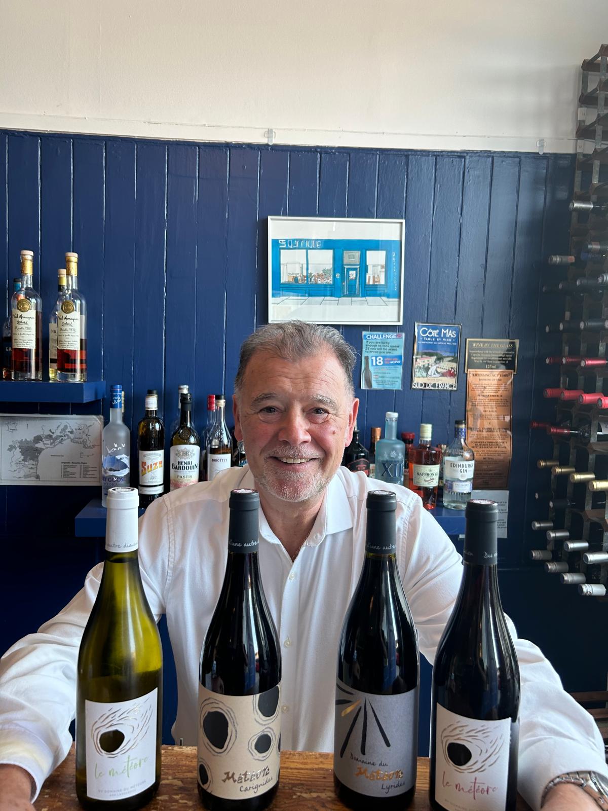 Jean-Michele with bottles of wine